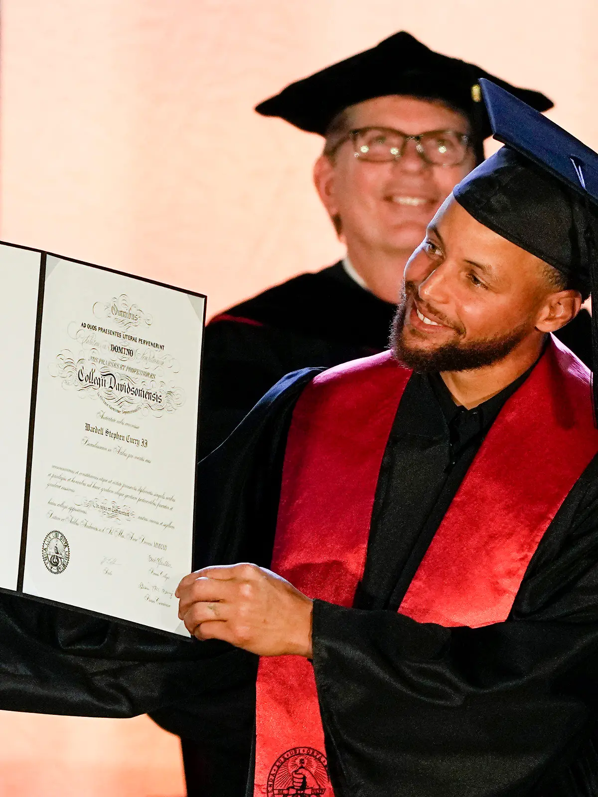 Golden State Warriors Stephen Curry poses with his diploma after his graduation ceremony at Davidson College on Wednesday, Aug. 31, 2022, in Davidson, N.C. Curry was also inducted into the school's Hall of Fame and his number and jersey were retired during the event. (AP Photo/Chris Carlson)