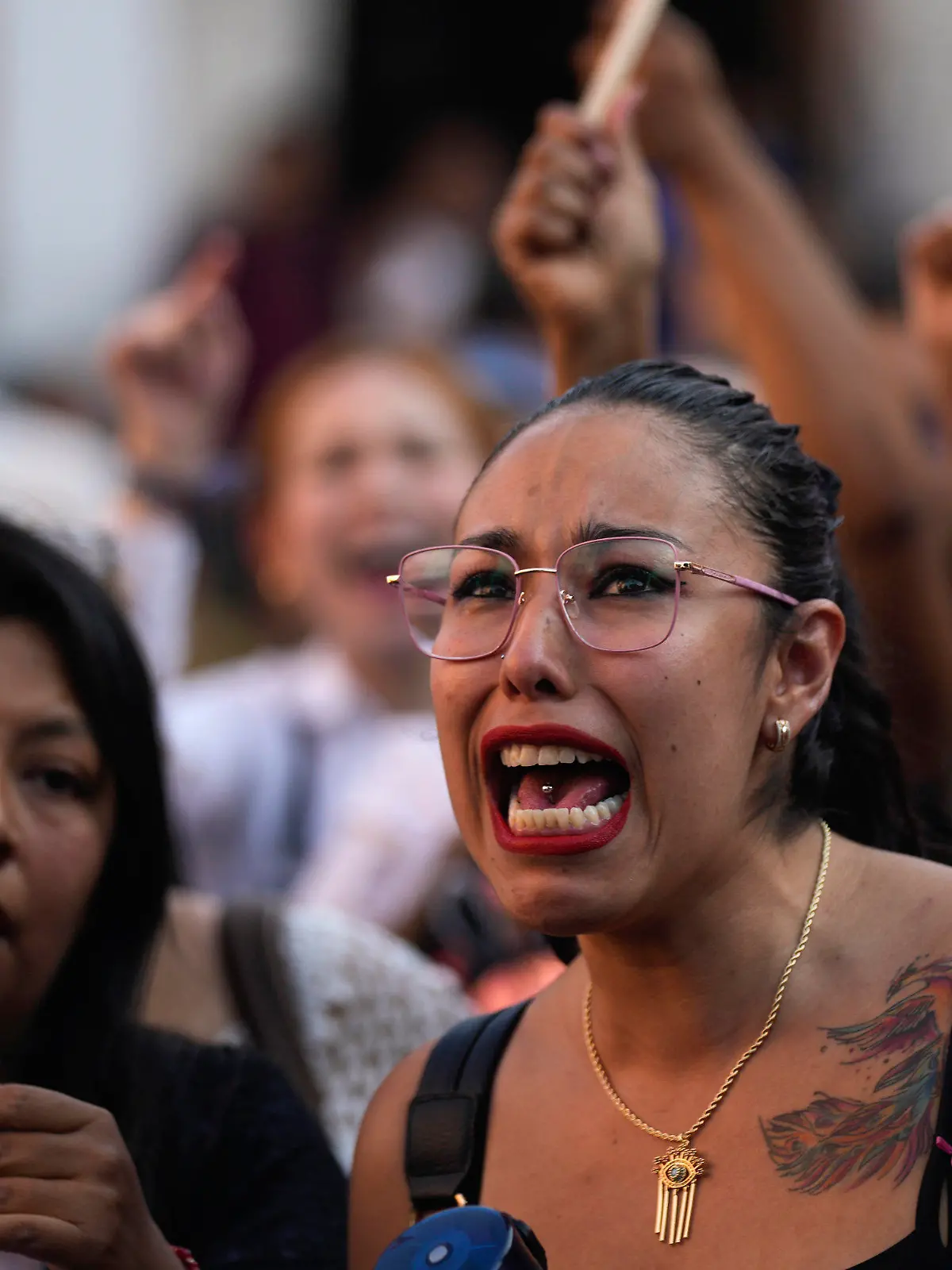 A woman chants the Spanish word for "justice" during a demonstration protesting the kidnapping and killing of an 8-year-old girl, in the main square of Taxco, Mexico, Thursday, March 28, 2024. Hours earlier a mob beat a woman to death because she was suspected of kidnapping and killing the young girl. (AP Photo/Fernando Llano)