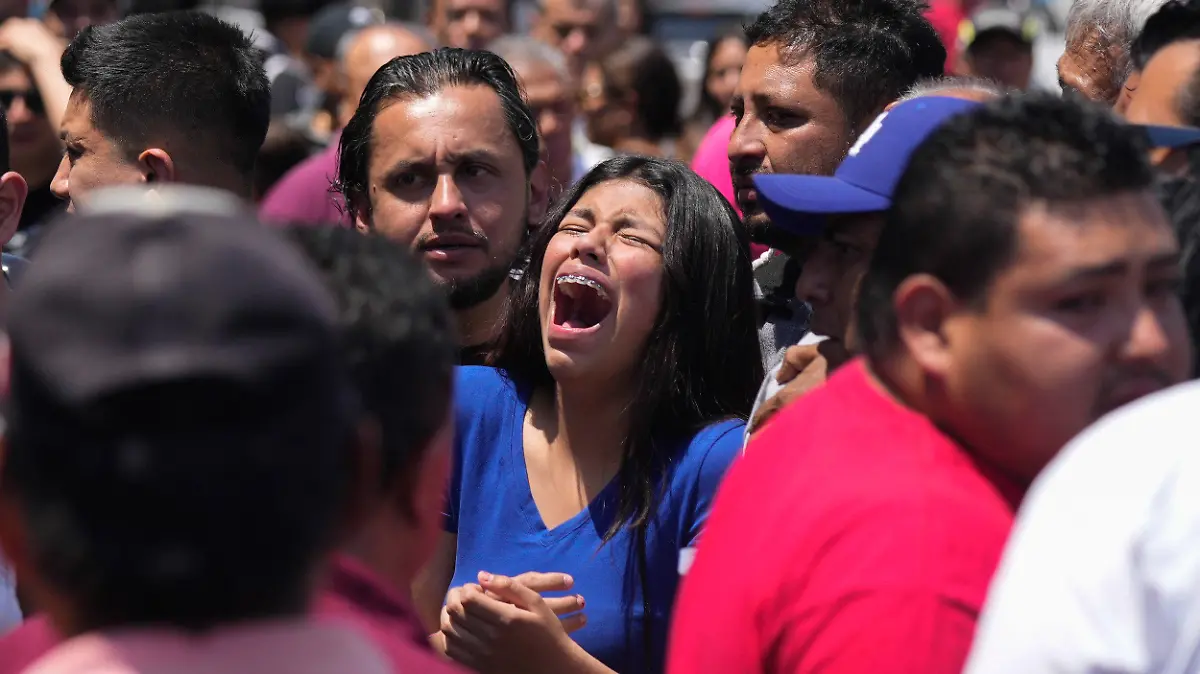 A relative of an 8-year-old girl, who was kidnapped the previous day, weeps as her body is handed over to family in Taxco, Mexico, Thursday, March 28, 2024. (AP Photo/Fernando Llano)