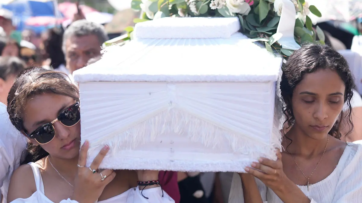 Relatives carry the coffin that contain the remains of a young girl named Camila, in Taxco, Mexico, Friday, March 29, 2024. The 8-year-old girl disappeared Wednesday; her body was found on a road on the outskirts of the city early Thursday. Later that day a mob beat a woman to death because she was suspected of kidnapping and killing the young girl. (AP Photo/Fernando Llano)