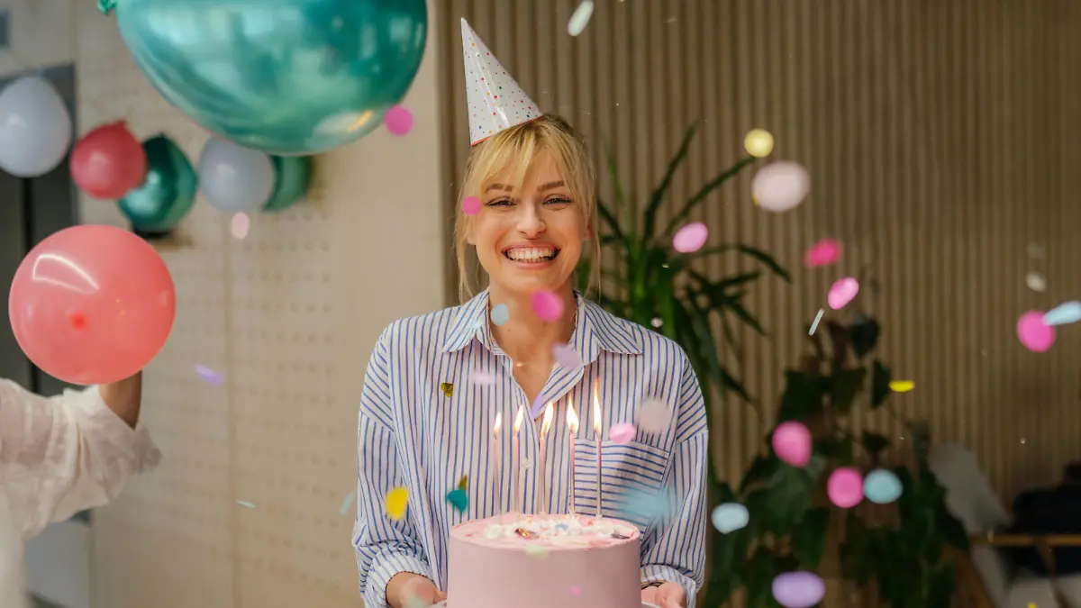 Photo of a young woman celebrating her birthday in the office