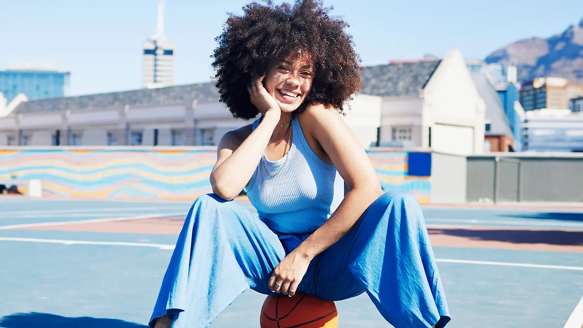 Basketball court, fashion and portrait of black woman with smile in trendy, urban style and edgy clothes in city. Sports, fitness and happy girl outdoors with ball for freedom, energy and confidence