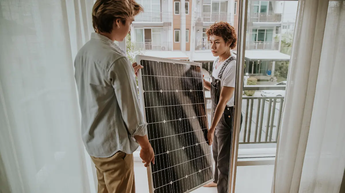 Two Thai nonbinary people are settings solar panel on balconies of houses for environment friendly.