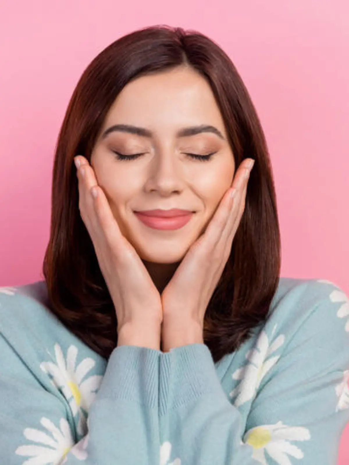 Photo of dreamy shiny lady wear turquoise clothes arms cheeks closed eyes isolated pink color background.
