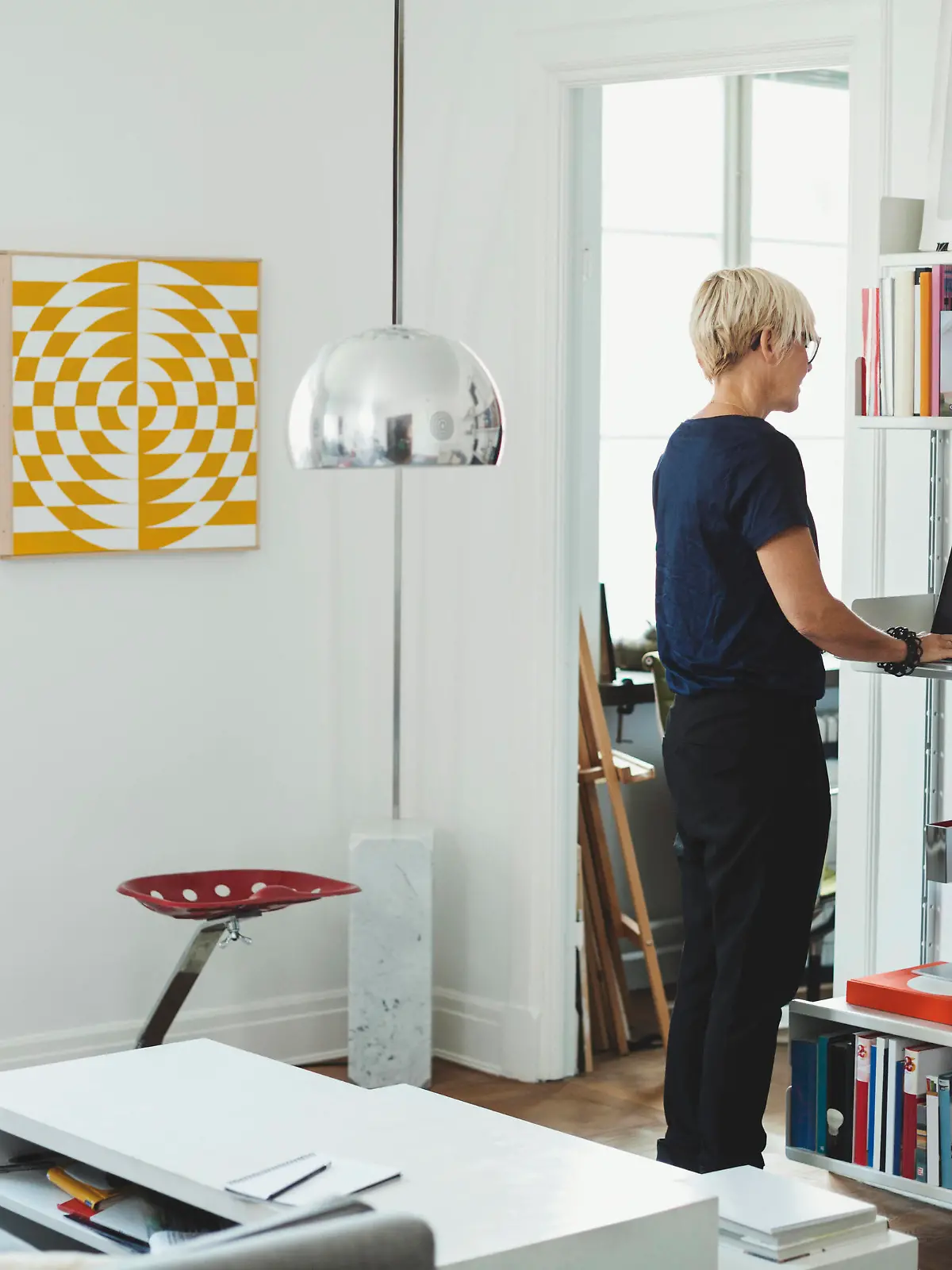  Rear view of product designer using laptop at shelf in home , model released, property released Copyright: xMaskotx , MA47852