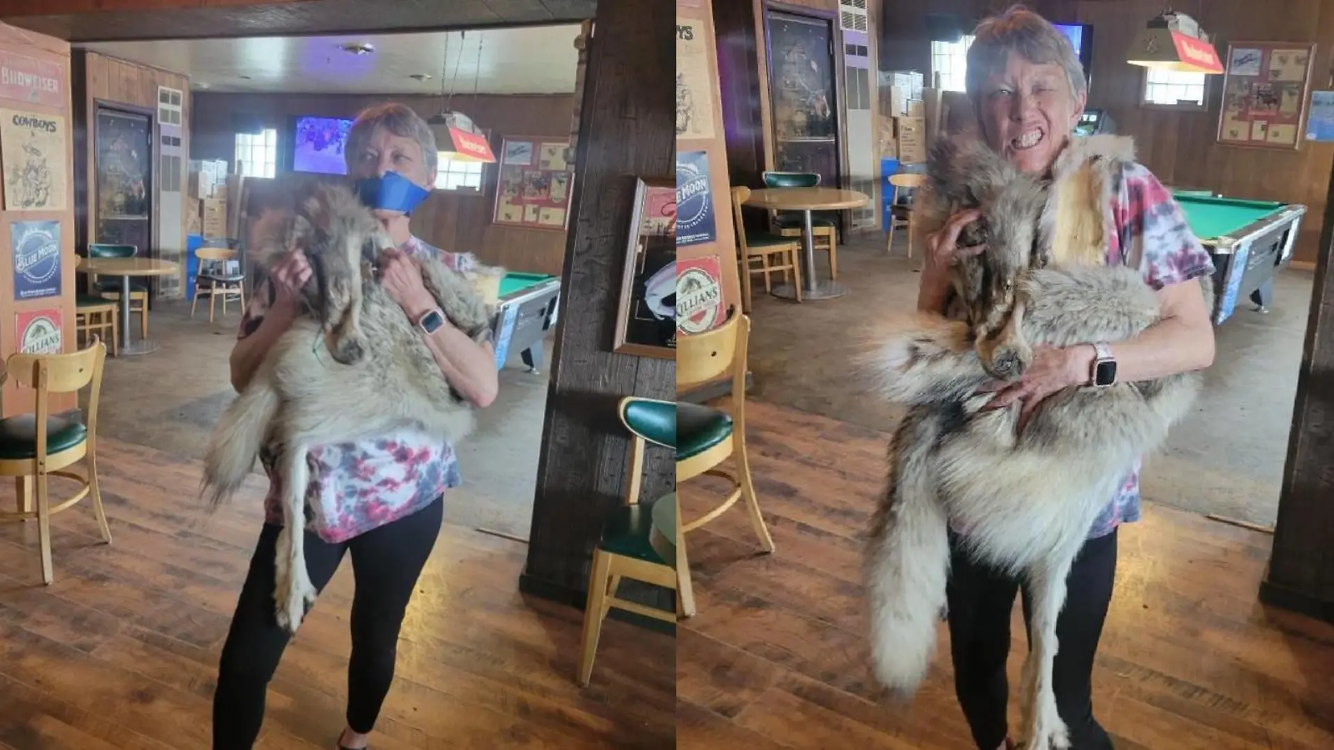 Eine Frau mit einem toten Wolf auf dem Arm.