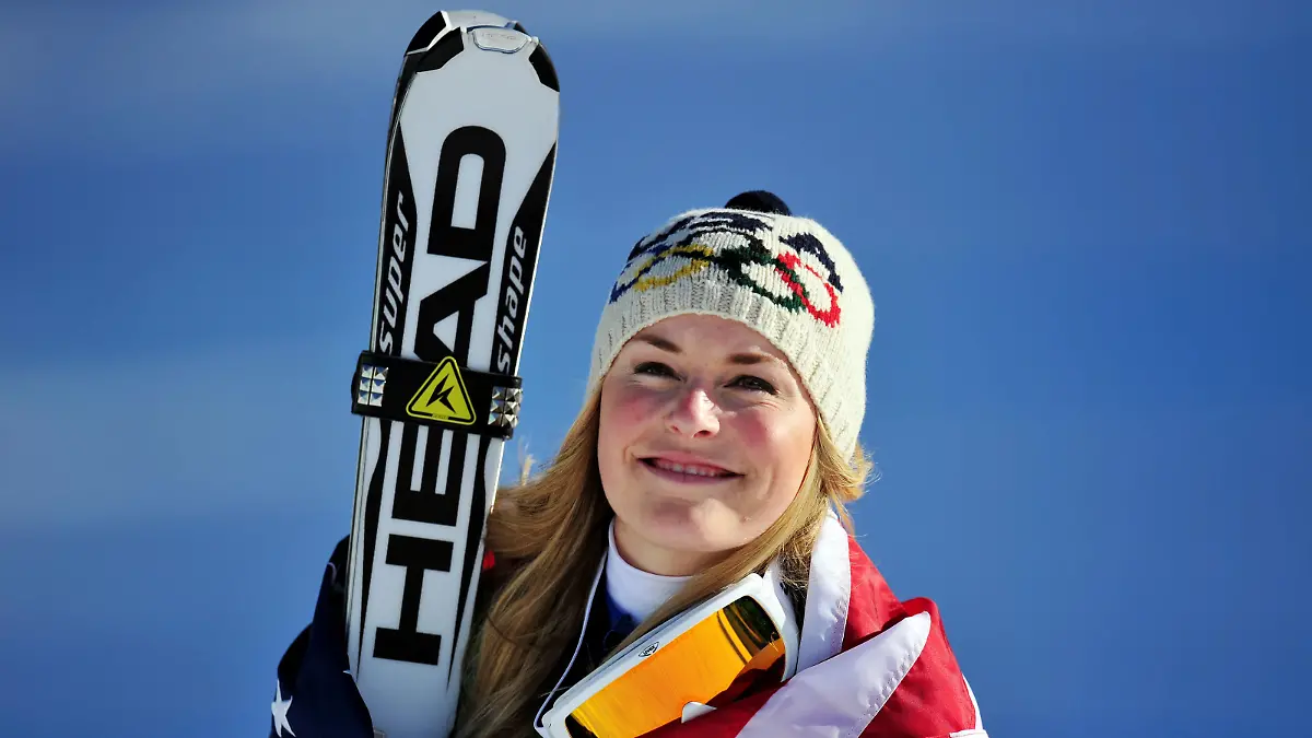 WHISTLER, BC - FEBRUARY 17:  Lindsey Vonn of the United States celebrates winning the gold medal during the flower ceremony for the Alpine Skiing Ladies Downhill on day 6 of the Vancouver 2010 Winter Olympics at Whistler Creekside on February 17, 2010 in Whistler, Canada.  (Photo by Clive Mason/Getty Images)
