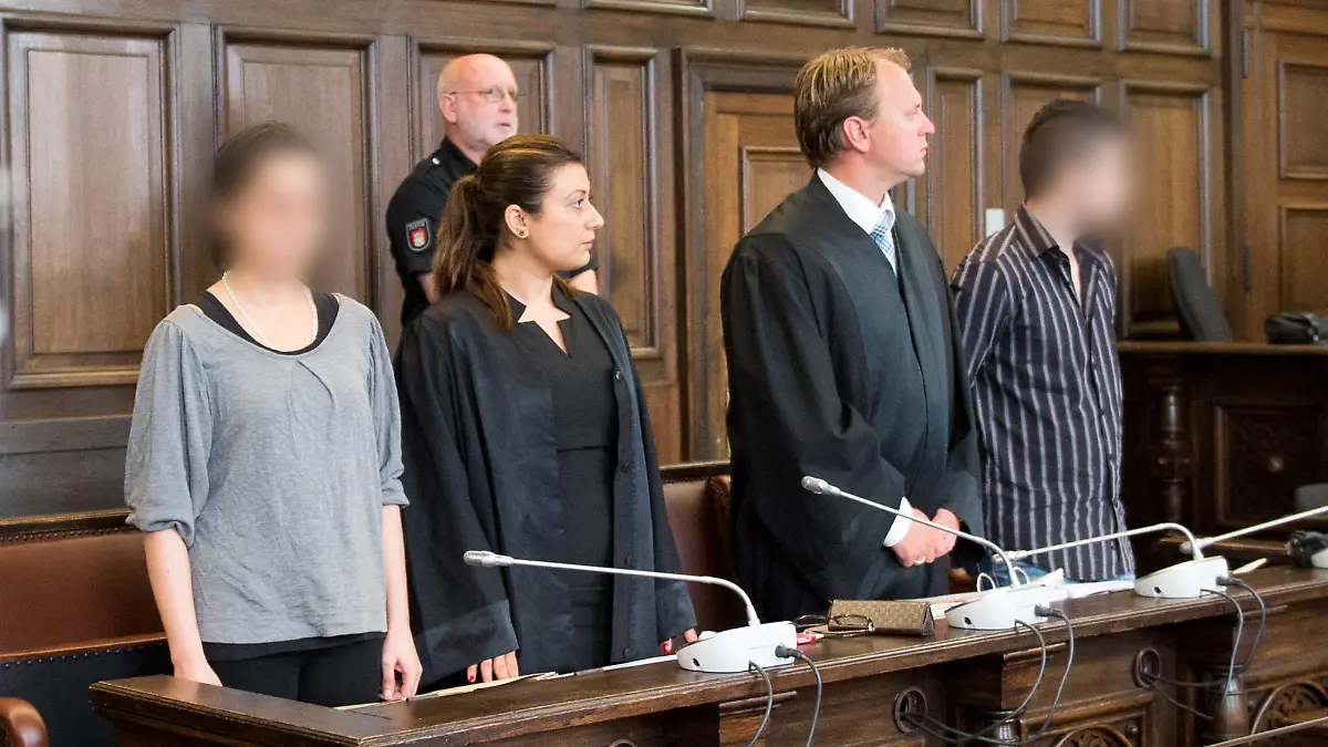 Die Eltern der getöteten Yagmur (l und r) stehen am 11.06.2014 zu Beginn des Prozesses im Landgericht in Hamburg in einem Gerichtssaal neben ihren Verteidiger  Sultan Maden-Celik (2.v.l.) und Carsten Kerschies (2.v.r.). Der 27-jährigen Mutter wird Mord, dem zwei Jahre jüngeren Vater Körperverletzung mit Todesfolge durch Unterlassen vorgeworfen. Das Mädchen war im Dezember 2013 nach einem Leberriss an inneren Blutungen gestorben. Foto: Daniel Reinhardt/dpa +++(c) dpa - Bildfunk+++