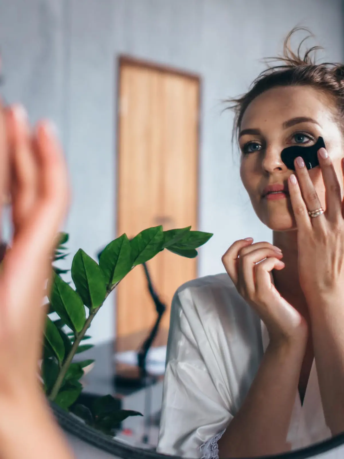 Young woman takes care of her facial skin at home.