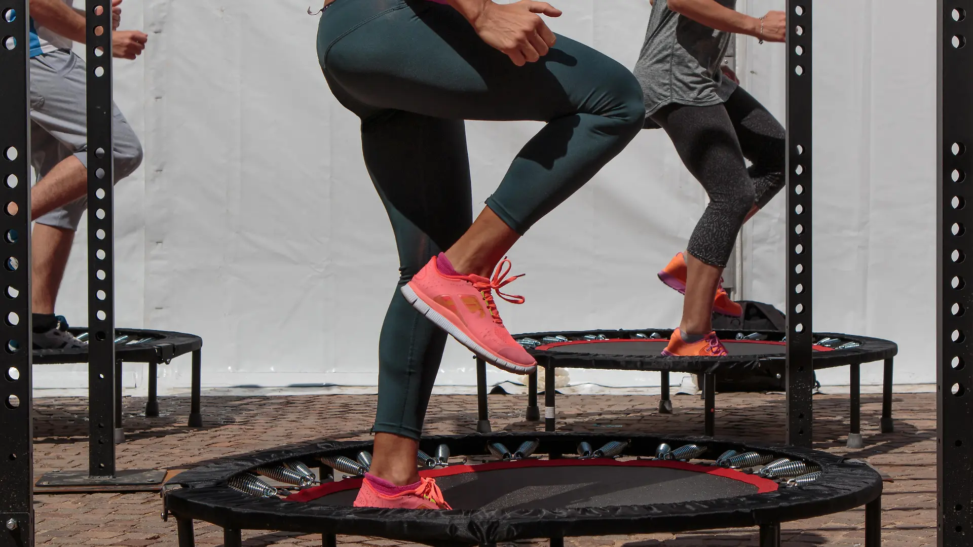 Rimini, Italy - june 2016: Mini Trampoline Workout: Girl doing Fitness Exercise in Class at Outdoor Gym in Summer Time during Public Fitness Annual Fetival in Rimini