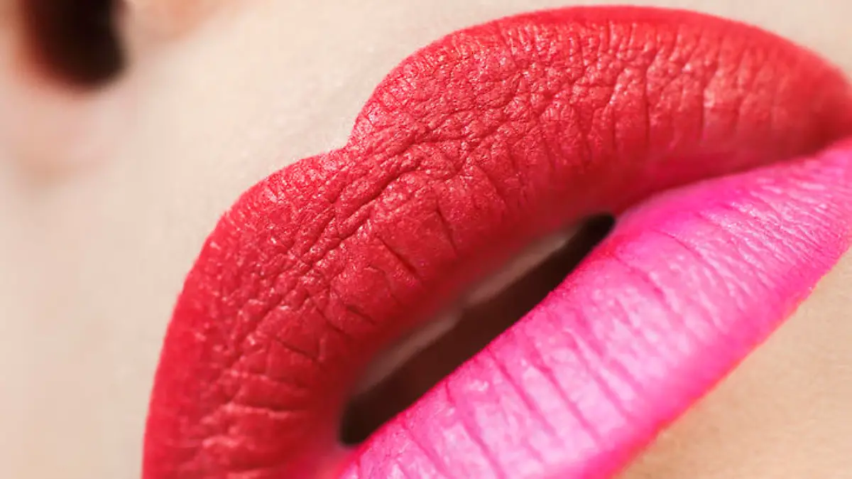 Multicolored trendy lip makeup with pink and red lipstick closeup.