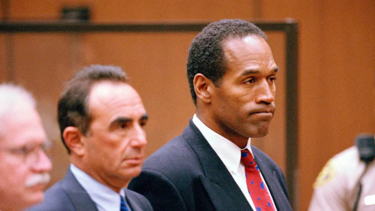 FILE - O.J. Simpson stands as he listens to Municipal Judge Kathleen Kennedy-Powell as she reads her decision to hold him over for trial on July 8, 1994, in connection with the June 12 slayings of his ex-wife Nicole Brown Simpson and Ronald Goldman. Simpson, the decorated football superstar and Hollywood actor who was acquitted of charges he killed his former wife and her friend but later found liable in a separate civil trial, has died. He was 76.  (AP Photo/Eric Draper, Pool, File)