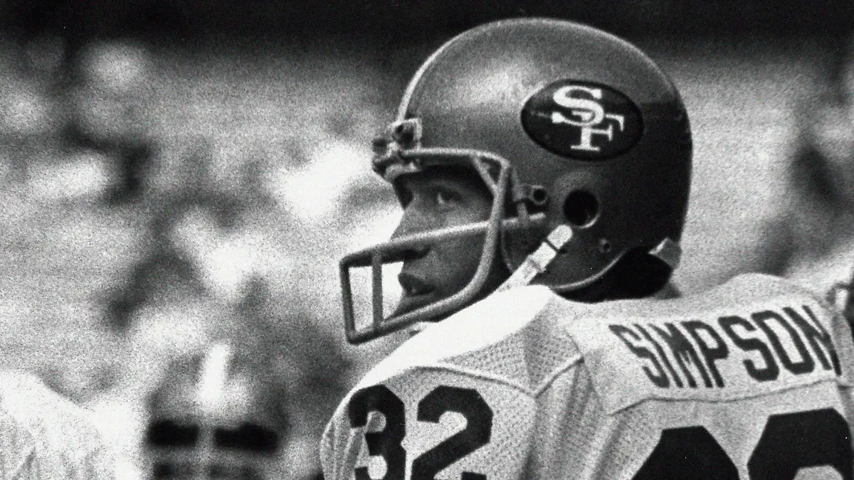 FILE - San Francisco 49ers running back O.J. Simpson looks over his shoulder at fans in the stands calling for his attention before an NFL football game against the Atlanta Falcons game in Atlanta, Sunday, Dec. 16 1979. O.J. Simpson, the decorated football superstar and Hollywood actor who was acquitted of charges he killed his former wife and her friend but later found liable in a separate civil trial, has died. He was 76. (AP Photo/Charles Kelly, File)