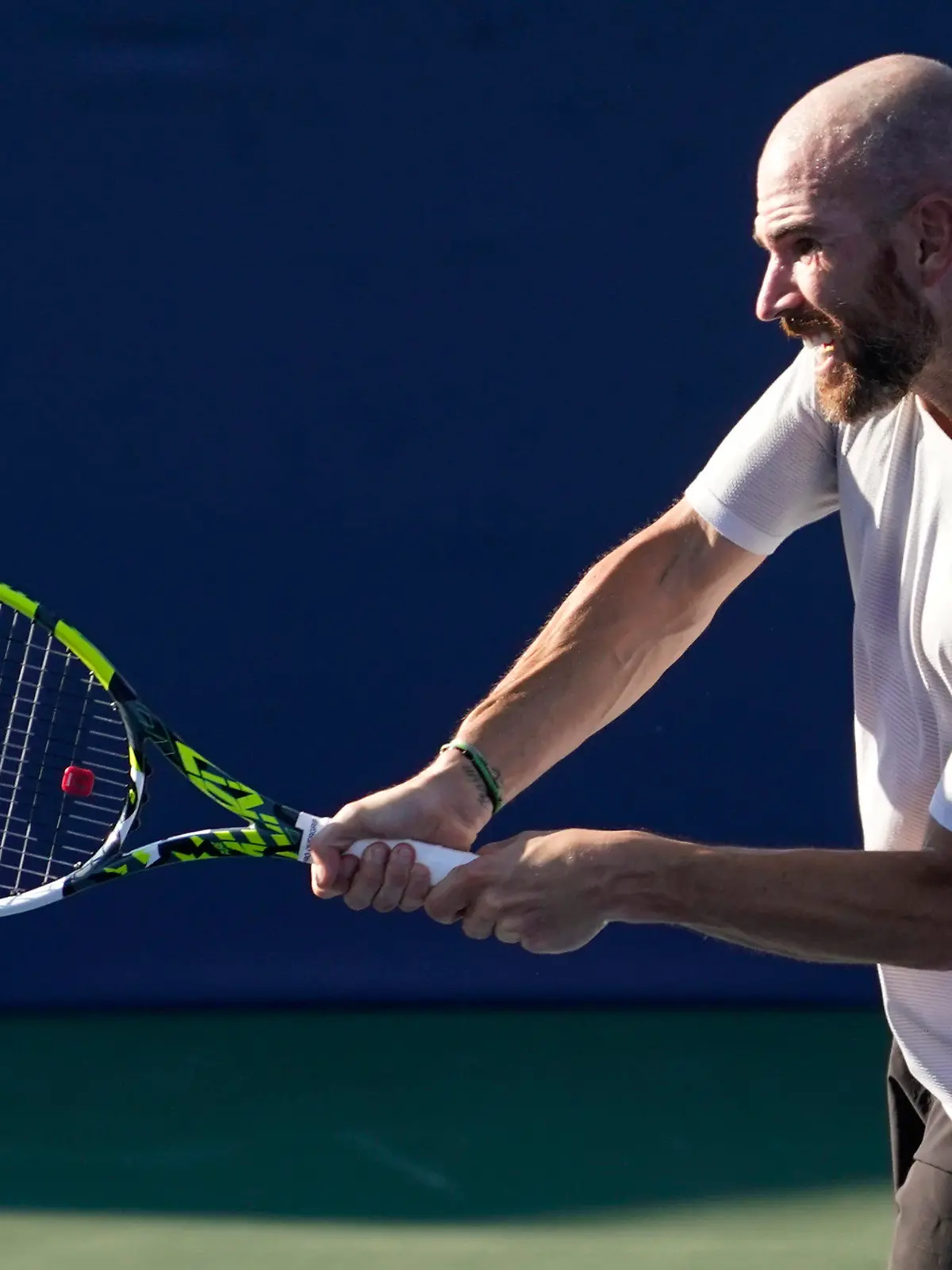 Adrian Mannarino, of France, returns a shot against Laslo Djere, of Serbia, during the championship match of the Winston-Salem Open tennis tournament in Winston-Salem, N.C., Saturday, Aug. 27, 2022. (AP Photo/Chuck Burton)