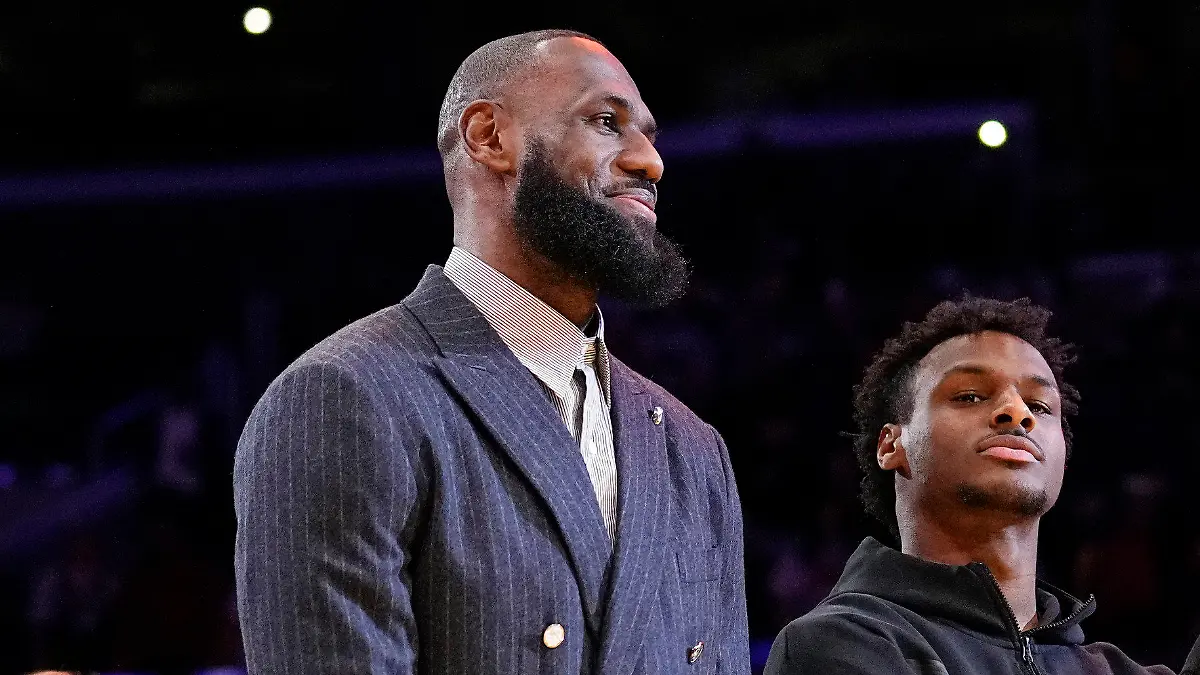 FILE - Los Angeles Lakers forward LeBron James, second from left, Bronny James, center, and Bryce James stand during a ceremony honoring LeBron James as the NBA's all-time leading scorer, before the Lakers' basketball game against the Milwaukee Bucks on Feb. 9, 2023, in Los Angeles. Bronny James was hospitalized in stable condition Tuesday, July 25, 2023, a day after going into cardiac arrest while participating in a practice at the University of Southern California, a family spokesman said. (AP Photo/Mark J. Terrill)