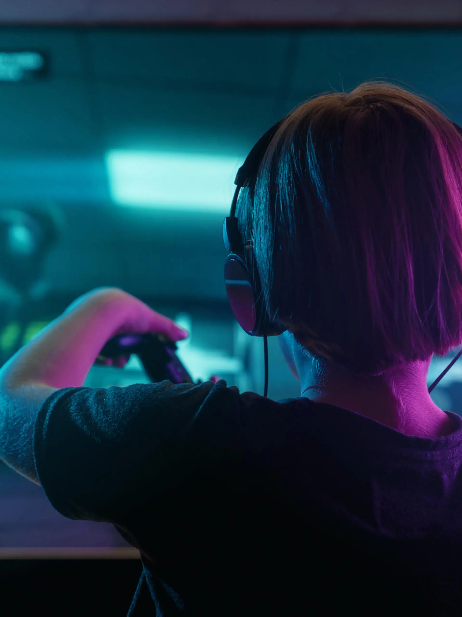 Little boy playing video game in the dark room