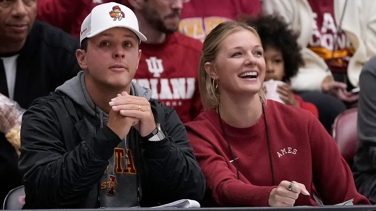 San Francisco 49ers quarterback Brock Purdy, left, and his wife, Jenna, watch players warm up before a second-round college basketball game in the women's NCAA Tournament between Stanford and Iowa State in Stanford, Calif., Sunday, March 24, 2024. (AP Photo/Jeff Chiu)
