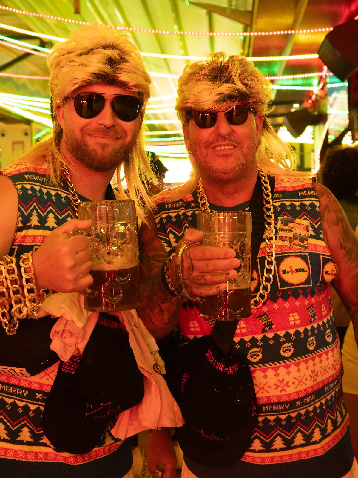 PRODUKTION - 17.04.2024, Spanien, Palma de Mallorca: Zwei Gäste halten im Bierkönig Bierkrüge in der Hand. Am Ballermann kommt der Partybetrieb wieder auf Touren. Schon zum Auftakt ist im Bierkönig kaum noch ein Durchkommen. (zu dpa «Biene Maja auf Mallorca: Ballermann schon zum Saisonauftakt rappelvoll») Foto: Mar Granel/dpa +++ dpa-Bildfunk +++
