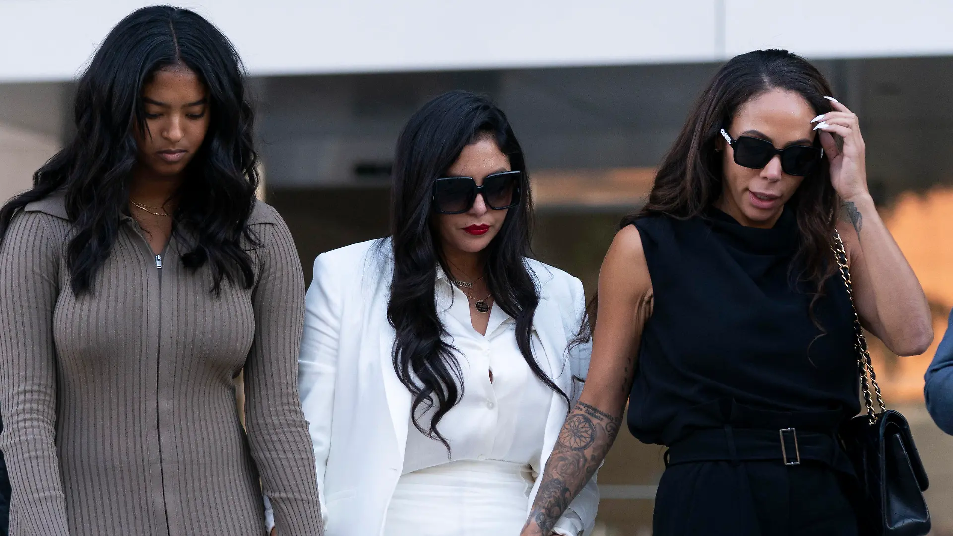 Vanessa Bryant, center, Kobe Bryant's widow, leaves a federal courthouse with her daughter, Natalia, left, and soccer player Sydney Leroux in Los Angeles, Wednesday, Aug. 24, 2022. A federal jury has found that Los Angeles County must pay Bryant's widow $16 million over photos of the NBA star's body at the site of the 2020 helicopter crash that killed him. (AP Photo/Jae C. Hong)