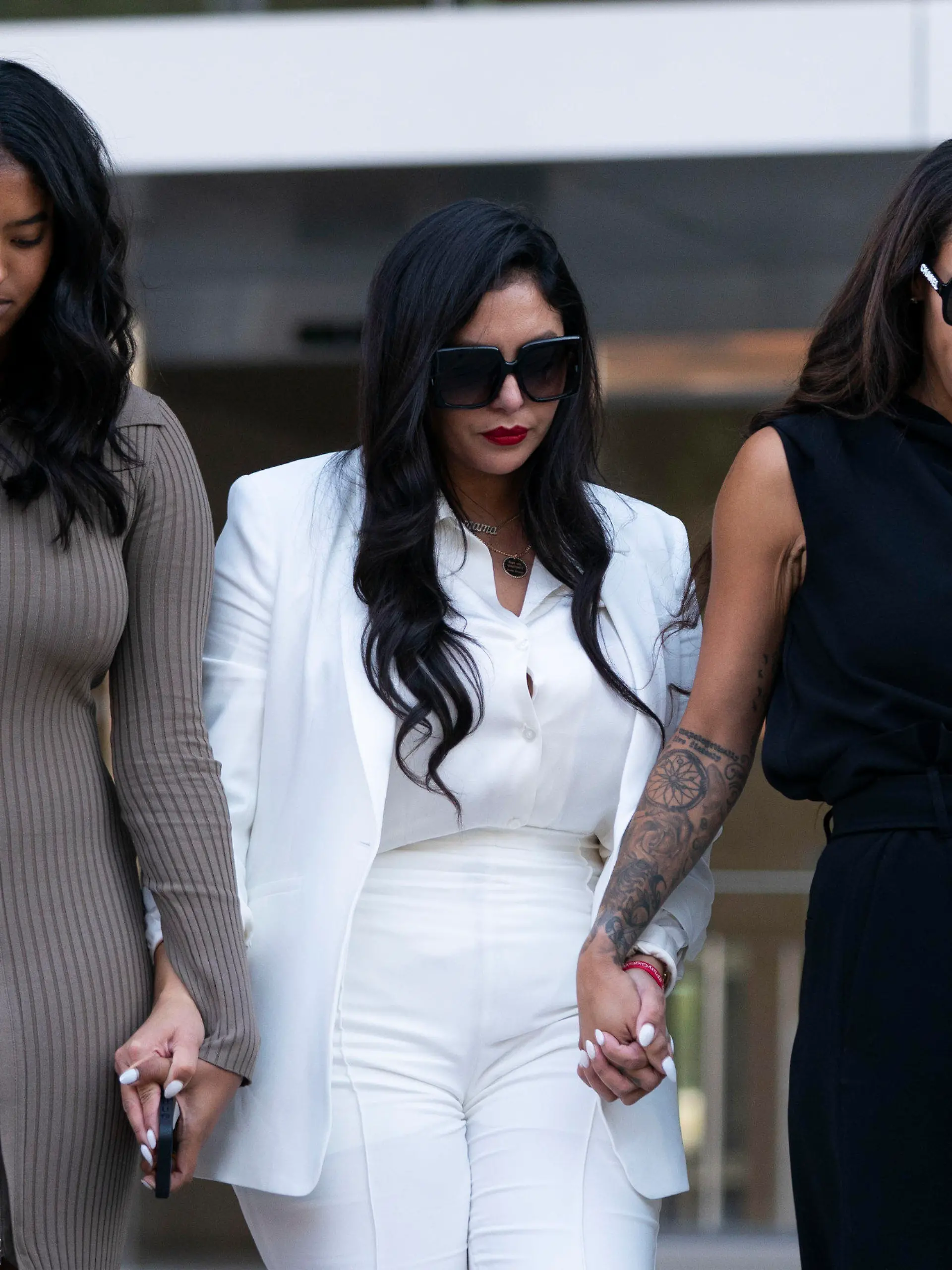 Vanessa Bryant, center, Kobe Bryant's widow, leaves a federal courthouse with her daughter, Natalia, left, and soccer player Sydney Leroux in Los Angeles, Wednesday, Aug. 24, 2022. A federal jury has found that Los Angeles County must pay Bryant's widow $16 million over photos of the NBA star's body at the site of the 2020 helicopter crash that killed him.  (AP Photo/Jae C. Hong)