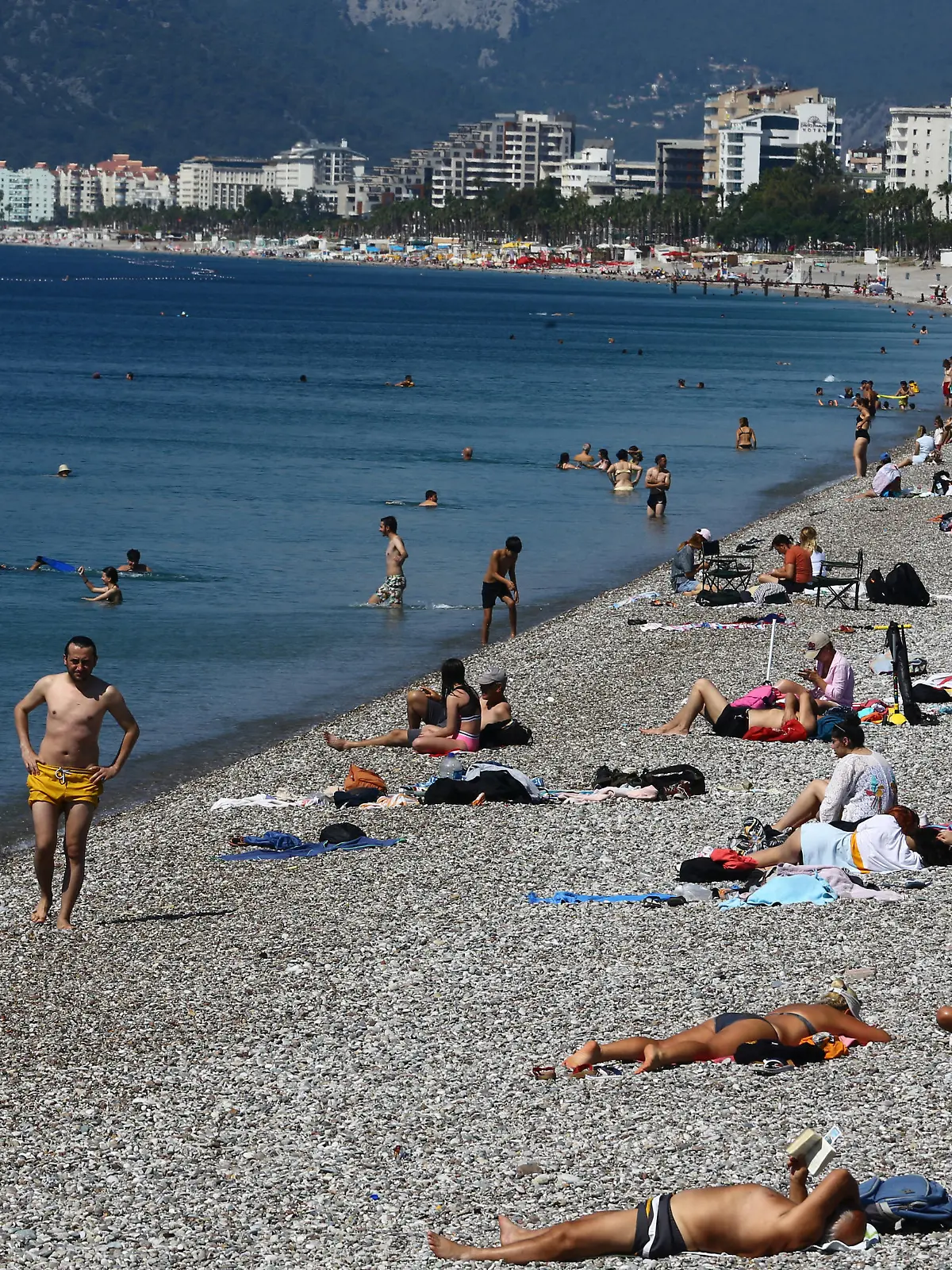 People sunbathe on Konyaalti beach, amid the COVID-19 outbreak, in the southern resort city of Antalya, Turkey June 19, 2020. Picture taken June 19, 2020. REUTERS/Kaan Soyturk