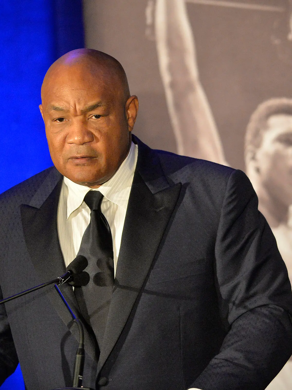 Former heavyweight boxing champion George Foreman gives a stern look to Muhammad Ali during the Sports Illustrated Legacy Awards Thursday, Oct. 1, 2015, in Louisville, Ky. Sports Illustrated announced that it will dedicate the franchise's Sportsman Legacy Award in the name of boxing legend Muhammad Ali. (AP Photo/Timothy D. Easley)