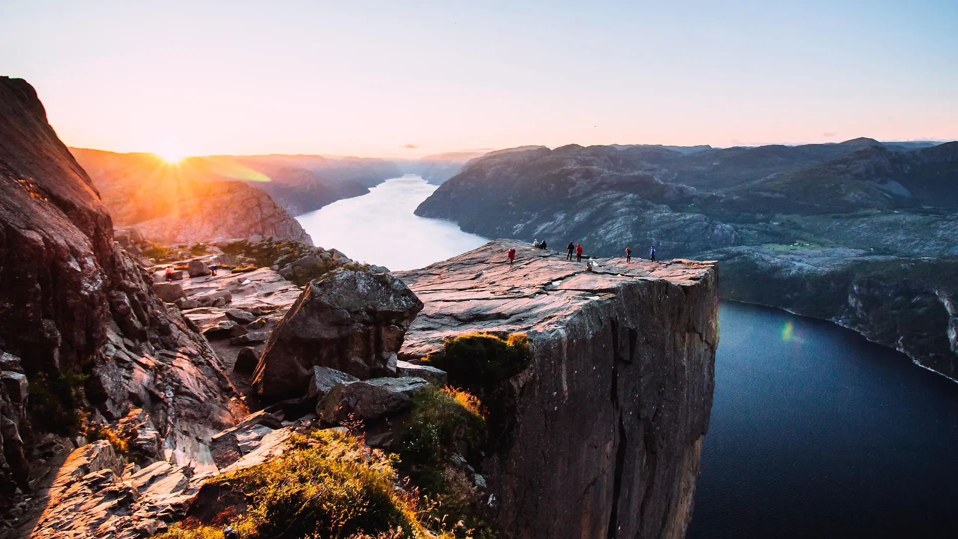 Warm orange sunrise at the Preikestolen in the summer in Norway