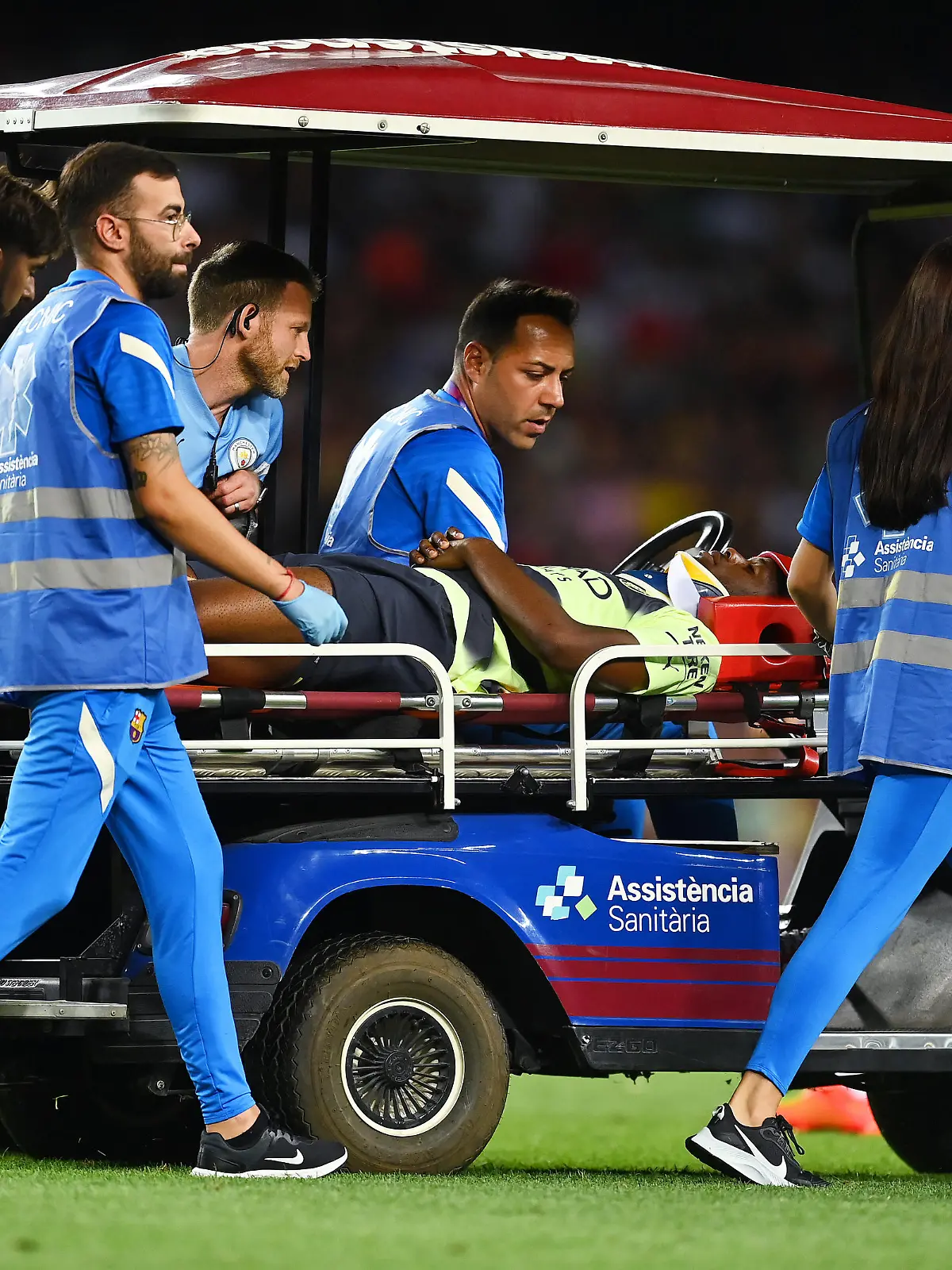 BARCELONA, SPAIN - AUGUST 24: Luke Mbete-Tabu of Manchester City is stretched off after picking up a injury during the friendly match between FC Barcelona and Manchester City at Camp Nou on August 24, 2022 in Barcelona, Spain. (Photo by David Ramos/Getty Images)