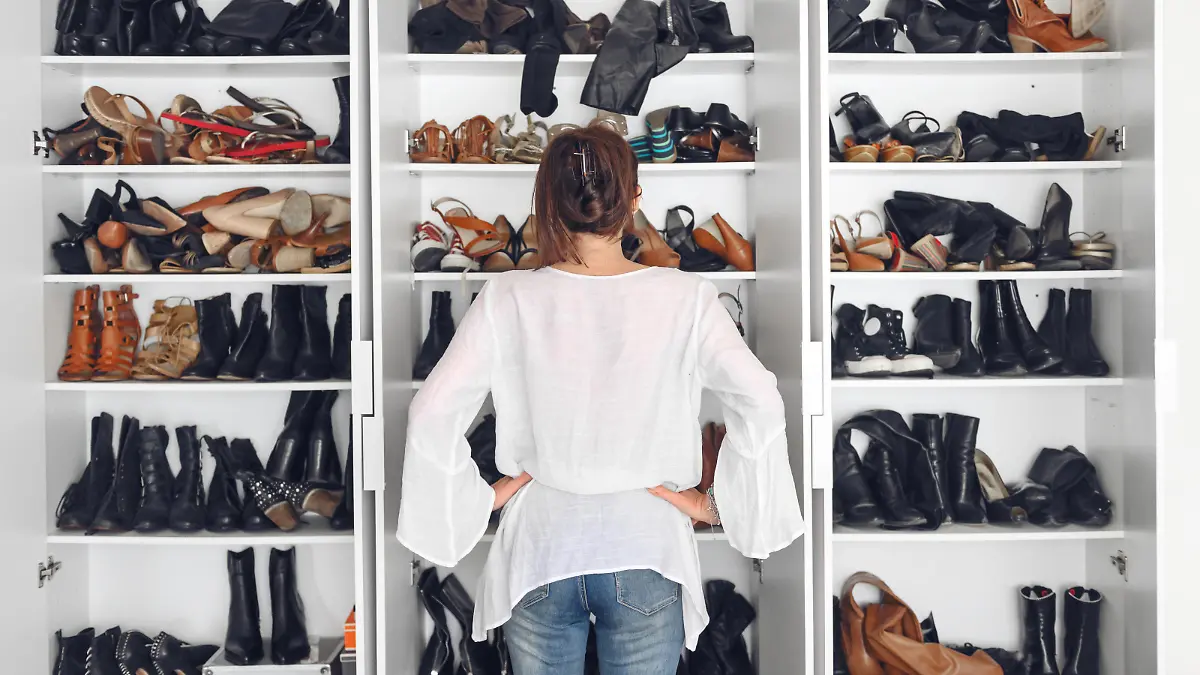 Woman cleaning shoes closet, while quarantined at home, Quebec, canada