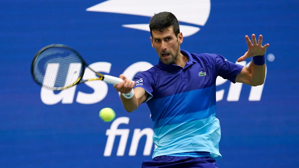 FILE - In this Sept. 12, 2021, file photo, Novak Djokovic, of Serbia, returns a shot to Daniil Medvedev, of Russia, during the men's singles final of the U..S. Open tennis championships in New York. Djokovic will not play in the U.S. Open, as expected, because he is not vaccinated against COVID-19 and thus is not allowed to travel to the United States. Djokovic announced his withdrawal from the year’s last Grand Slam tournament on Twitter on Thursday, Aug. 25, 2022, hours before the draw for the event was revealed. (AP Photo/John Minchillo, File)