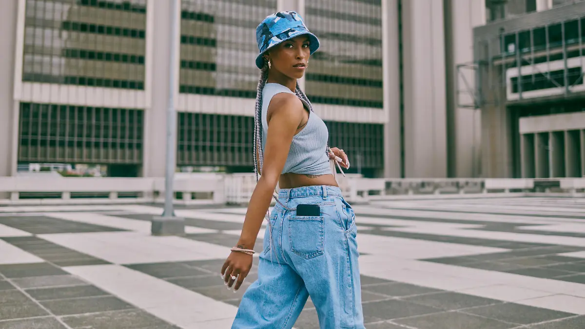 Shot of a trendy young woman walking through the city