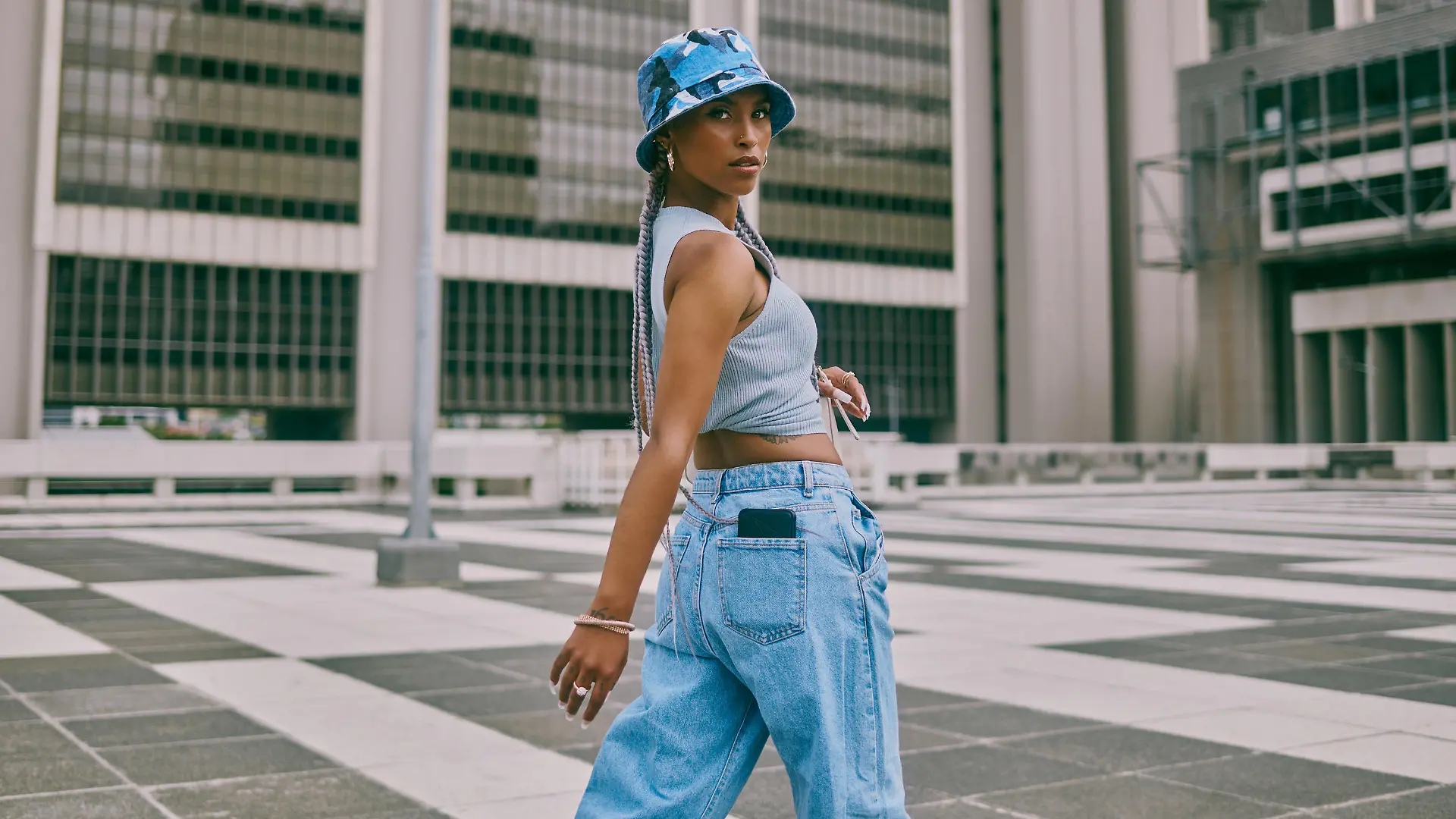 Shot of a trendy young woman walking through the city