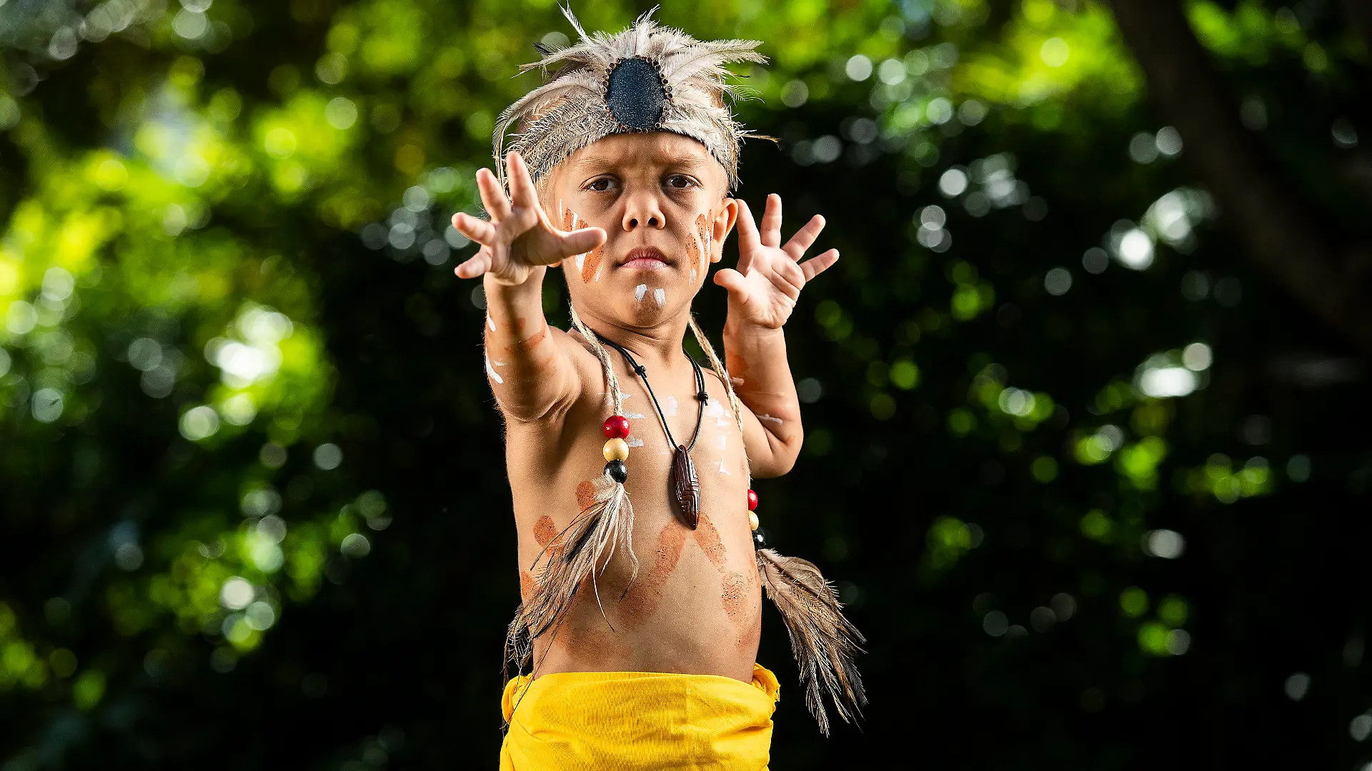 BRISBANE, AUSTRALIA - APRIL 13: Quaden Bayles poses for a portrait on April 13, 2020 in Brisbane, Australia. 9-year-old Quaden Bayles, who born with achondroplasia dwarfism, is an Aboriginal Australian from the Wirri nation of central Queensland. He is wearing a traditional corroboree dress specially made for him by family members. (Photo by Jono Searle/Getty Images)