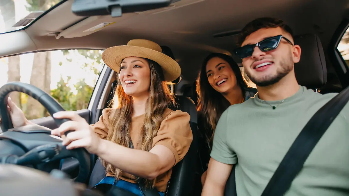 happy friends traveling by car