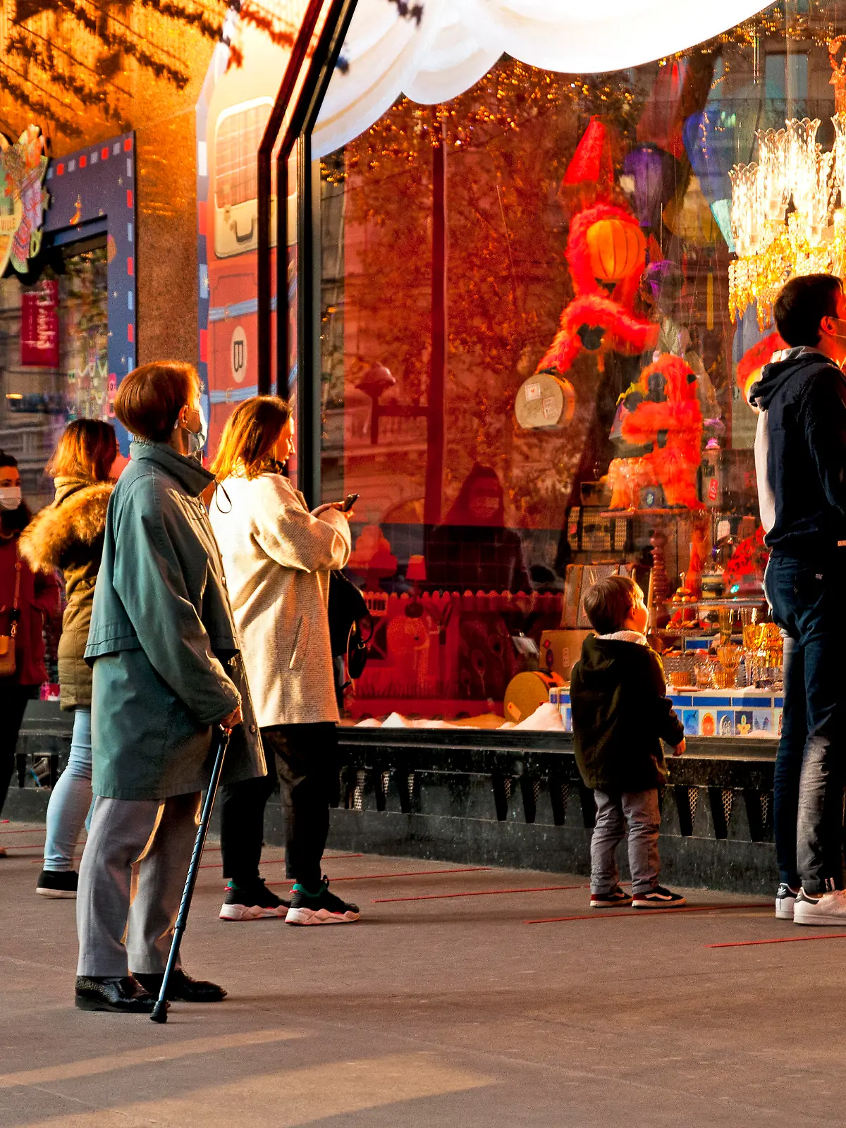 People in front of Galeries Lafayette department store windows, for Christmas. Paris, boulevard Haussmann in France. November 27, 2020