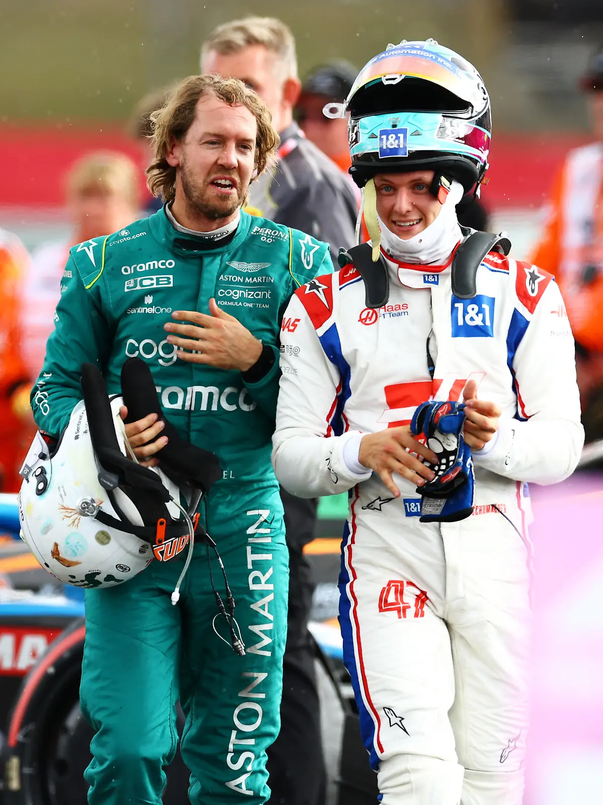 NORTHAMPTON, ENGLAND - JULY 03: Sebastian Vettel of Germany and Aston Martin F1 Team and Mick Schumacher of Germany and Haas F1 talk in parc ferme during the F1 Grand Prix of Great Britain at Silverstone on July 03, 2022 in Northampton, England. (Photo by Mark Thompson/Getty Images)