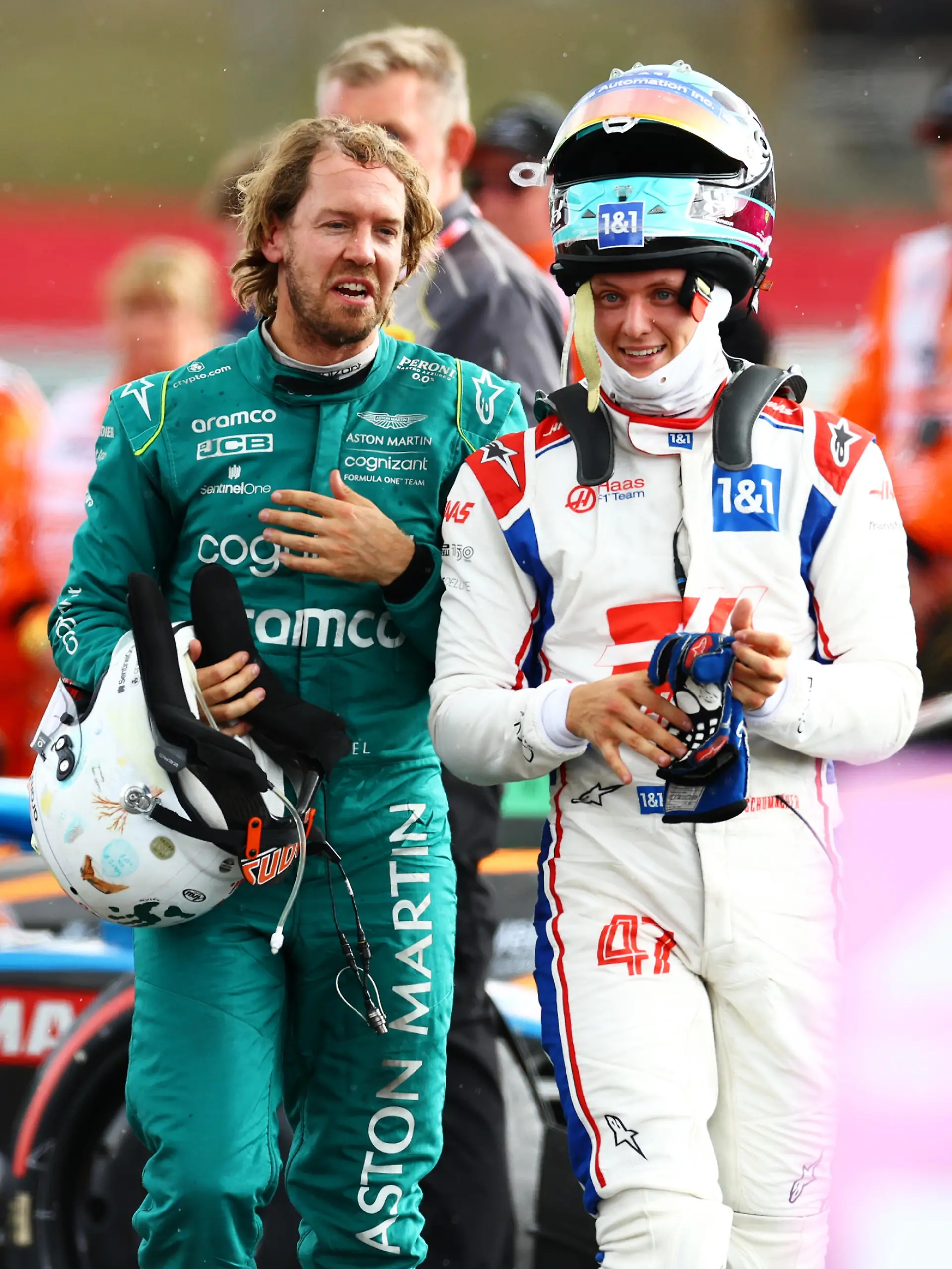 NORTHAMPTON, ENGLAND - JULY 03: Sebastian Vettel of Germany and Aston Martin F1 Team and Mick Schumacher of Germany and Haas F1 talk in parc ferme during the F1 Grand Prix of Great Britain at Silverstone on July 03, 2022 in Northampton, England. (Photo by Mark Thompson/Getty Images)