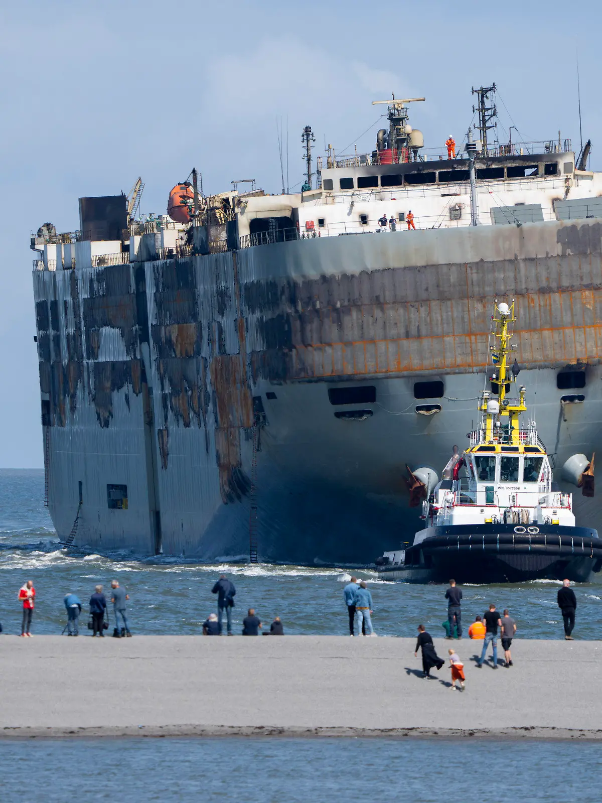 Stricken cargo ship Fremantle Highway, that caught fire while transporting thousands of cars, including nearly 500 electric vehicles, from Germany to Singapore, is towed into the port of Eemshaven, the Netherlands, on Thursday, Aug. 3, 2023. The ship that burned for almost a week close to busy North Sea shipping lanes and a world renowned migratory bird habitat will be salvaged at the northern Dutch port. (AP Photo/Peter Dejong)