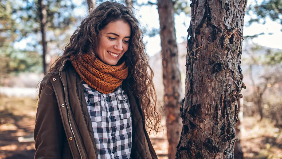 Photo of young woman walking in the forest