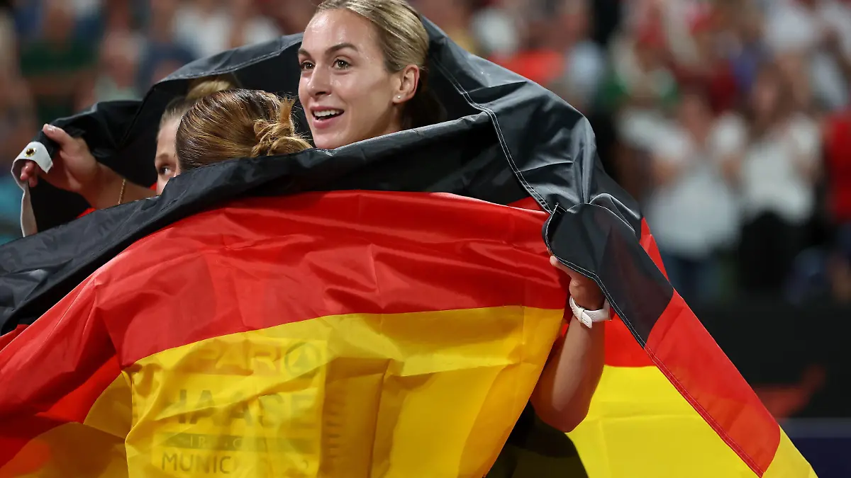 MUNICH, GERMANY - AUGUST 21: Gold medalists Lisa Mayer, Rebekka Haase  and Alexandra Burghardt of Germany celebrate after the Athletics - Women's 4x100m Relay Final on day 11 of the European Championships Munich 2022 at Olympiapark on August 21, 2022 in Munich, Germany. (Photo by Alexander Hassenstein/Getty Images)