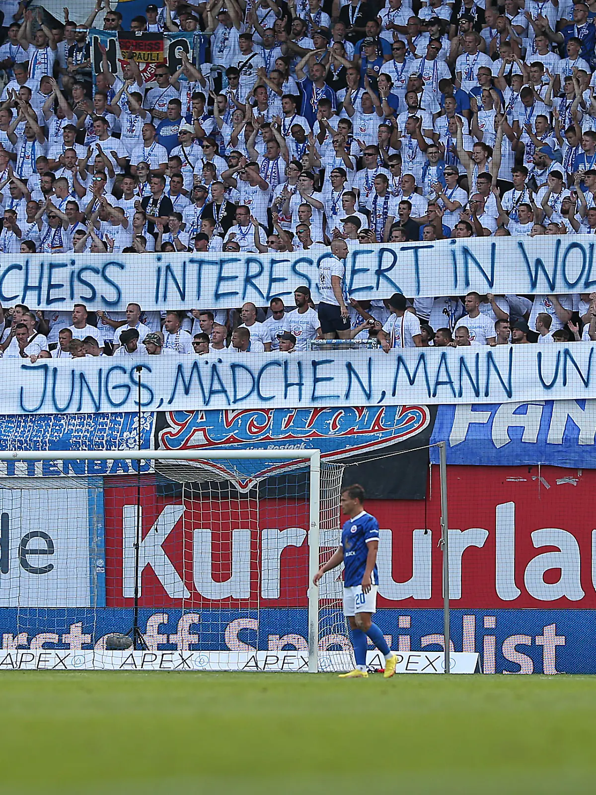 ROSTOCK, GERMANY - AUGUST 21: Supporters of FC Hansa Rostock holding up a sign with a slight jab towards FC St. Pauli and their latest action with the gender asterisk on the last home shirt during the Second Bundesliga match between F.C. Hansa Rostock and FC St. Pauli at Ostseestadion on August 21, 2022 in Rostock, Germany. (Photo by Cathrin Mueller/Getty Images)