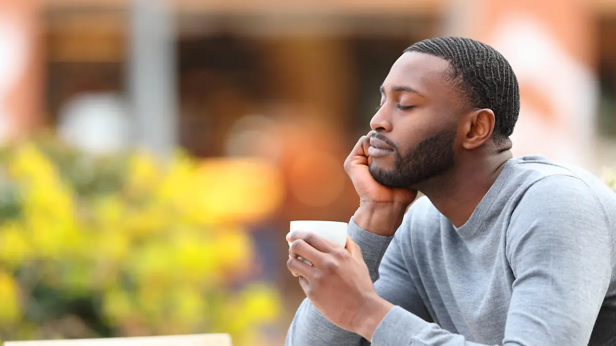 Man with black skin resting and relaxing drinking coffee