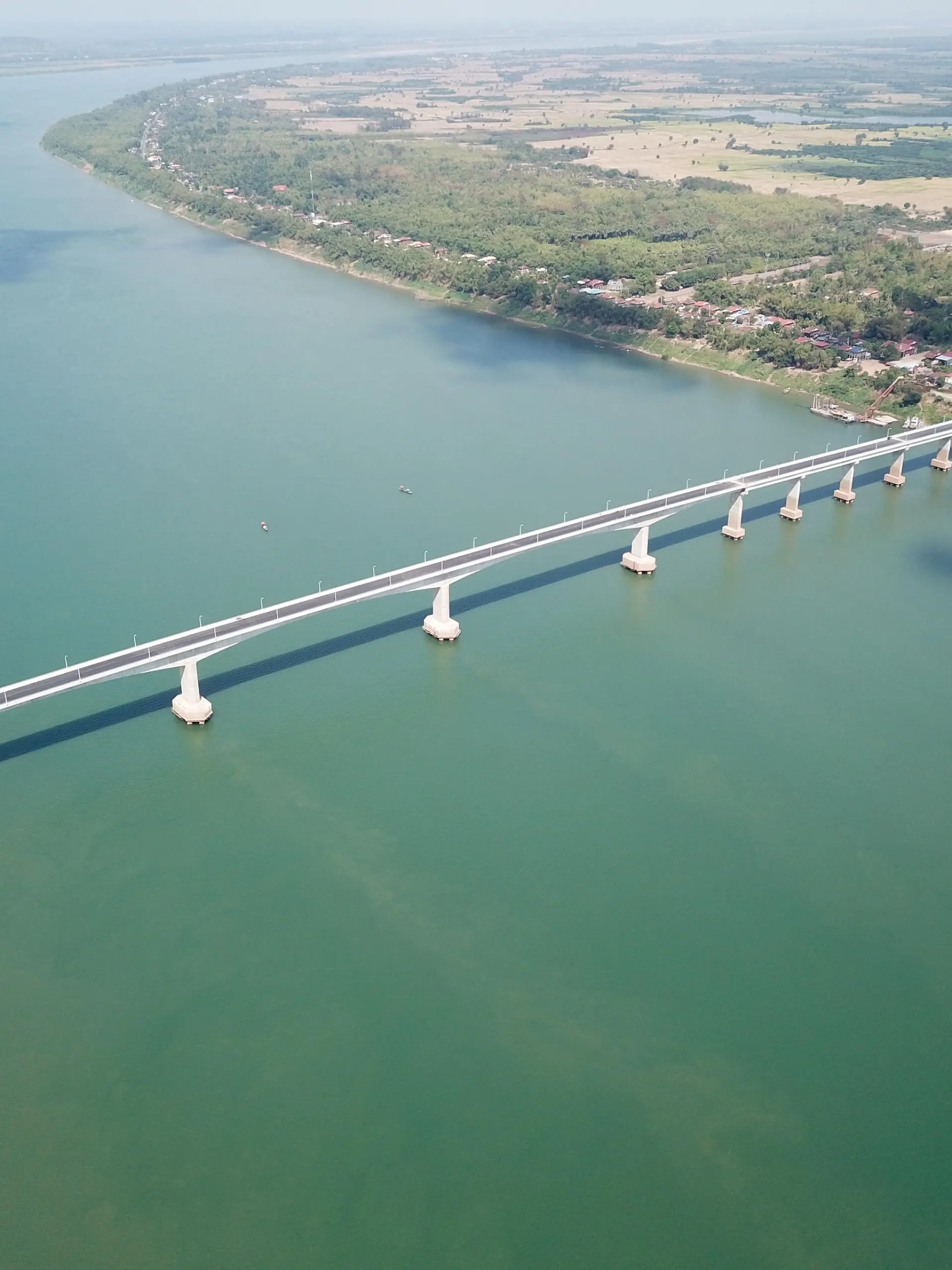 (210325) -- PHNOM PENH, March 25, 2021 (Xinhua) -- Aerial photo taken on March 11, 2021 shows the eighth Cambodia-China Friendship Bridge across the Mekong River, connecting Kampong Cham province and Tboung Khmum province in southeastern Cambodia. Construction work on the eighth Cambodia-China Friendship Bridge was completed earlier than schedule despite the COVID-19 pandemic, Cambodian Minister of Public Works and Transport Sun Chanthol said on Tuesday. (Shanghai Construction Group/Handout via Xinhua)