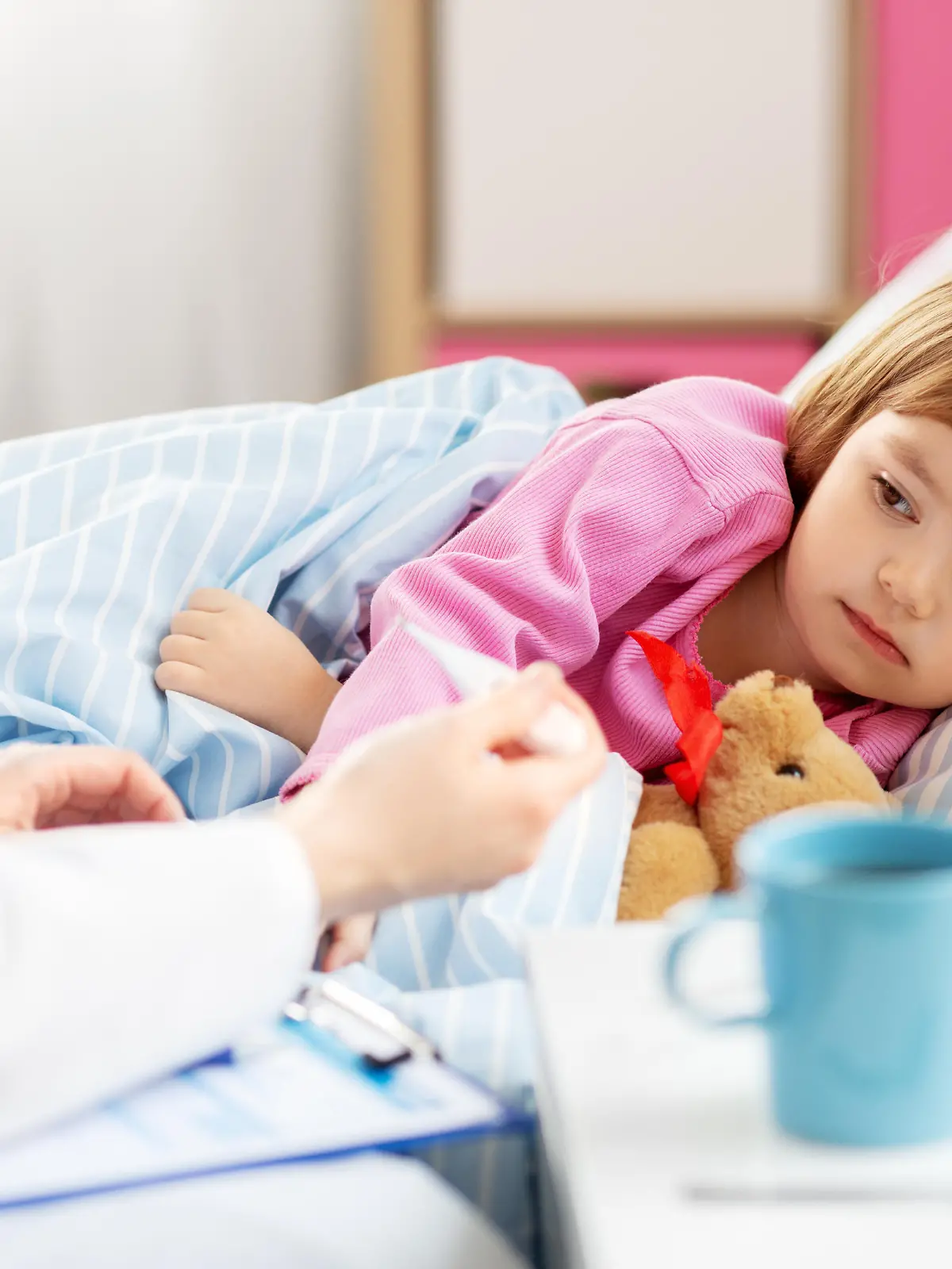 healthcare, medicine and people concept - close up of doctor with thermometer measuring temperature of little sick girl lying in bed at home