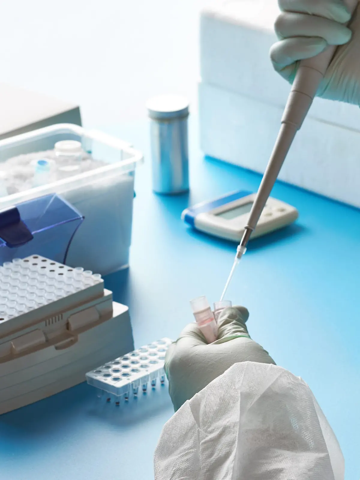 Epidemiologist in protective suit, mask and glasses works with patient swabs to detect specific region of 2019-nCoV virus causing Covid-19 viral pneumonia. SARS-COV-2 pcr diagnostics kit concept.