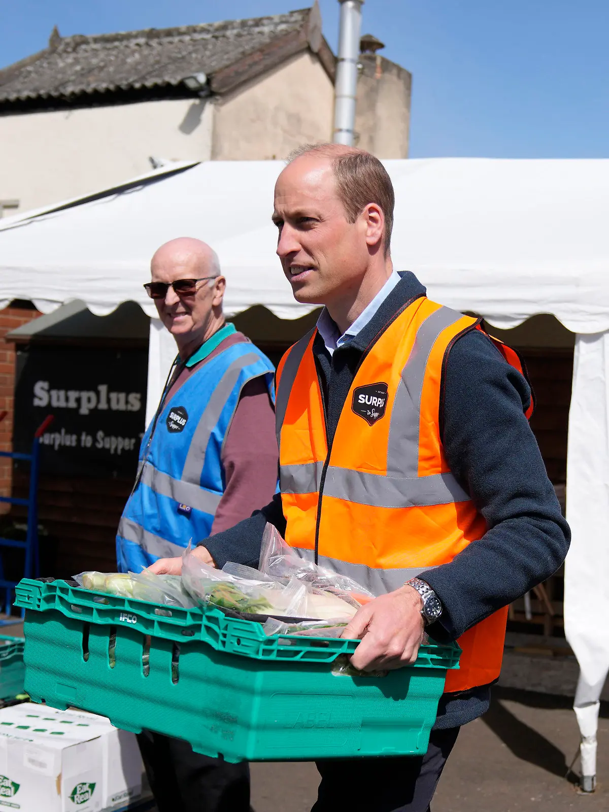 18.04.2024, Großbritannien, Sunbury-on-Thames: Der britische Prinz William (M) hilft beim Verladen von Lebensmitteln in einen Lieferwagen während eines Besuchs bei Surplus to Supper in Sunbury-on-Thames. Der Prinz besuchte Surplus to Supper, eine Wohltätigkeitsorganisation zur Umverteilung überschüssiger Lebensmittel, um sich über deren Arbeit zu informieren. Es ist sein erster Auftritt nach Bekanntwerden der Krebserkrankung seiner Ehefrau Kate, Princess of Wales. Foto: Alastair Grant/AP Pool/AP/dpa +++ dpa-Bildfunk +++