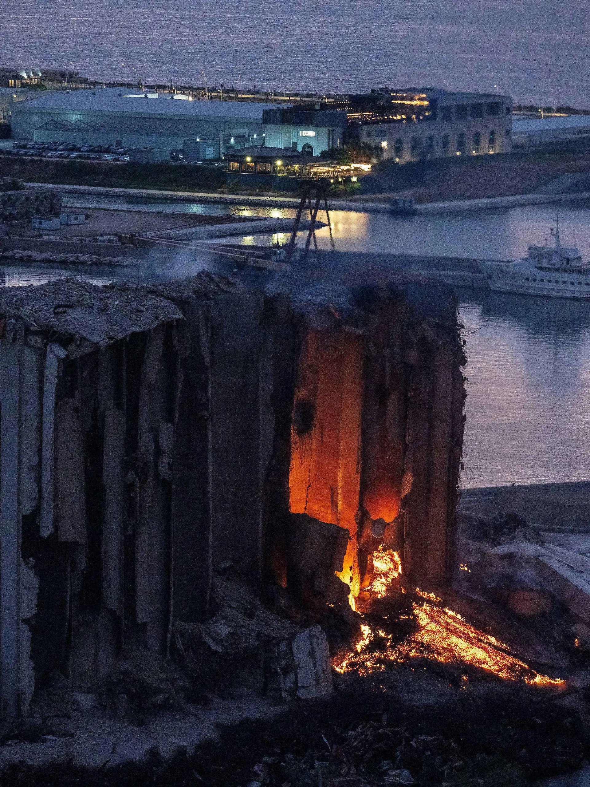 A large fire blaze continues in the grain silos that were heavily damaged in the August 2020 explosion at the port of Beirut, Lebanon, as seen on August 18, 2022. The fire has been on for several weeks and destroyed parts of the silos, that families of victims would like to keep and maintain as a memorial for the August 4, 2020 explosion. Photo by Ammar Abd Rabbo/ABACAPRESS.COM