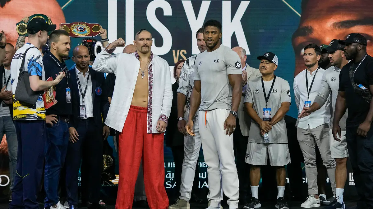 Heavyweight boxers Britain's Anthony Joshua, center right, and Ukraine's Oleksandr Usyk, center left, face off during a weigh-in at King Abdullah Sports City in Jeddah, Saudi Arabia, Friday, Aug. 19, 2022. Joshua is due to fight defending champion Usyk in a heavyweight boxing rematch in Jeddah on Aug. 20. (AP Photo/Hassan Ammar)