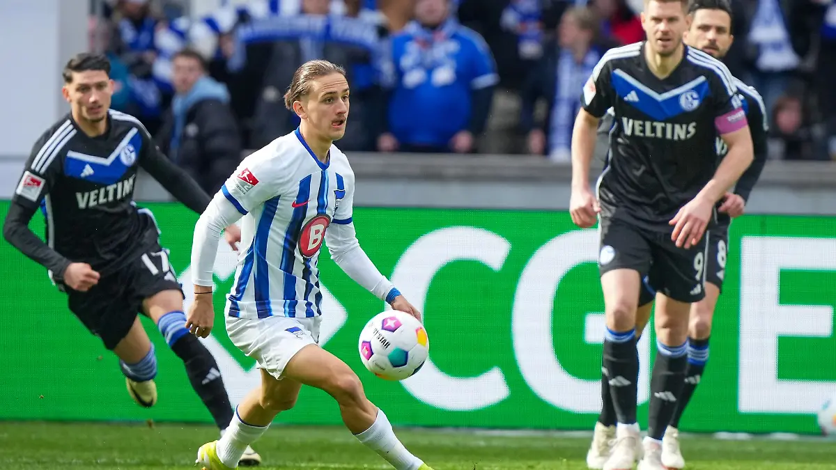 Herthas Michal Karbownik (M) nimmt den Ball vor Simon Terodde (r) von Schalke an.