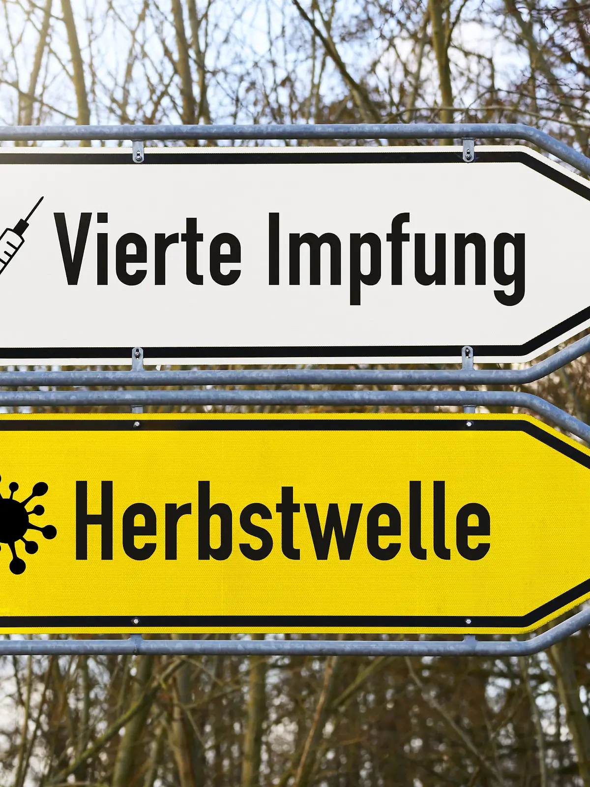 Straßenschilder mit den Aufschriften Herbstwelle und Vierte Impfung
